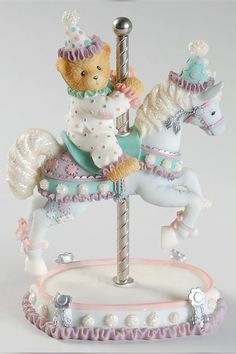 a teddy bear riding on top of a carousel