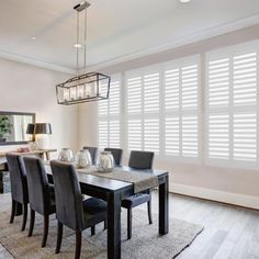 a dining room table with chairs and a chandelier