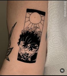 a person with a tattoo on their arm that has an image of a demon in it