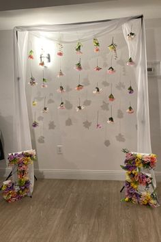 a room with flowers hanging from the ceiling