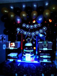 a birthday party with balloons, cake and decorations