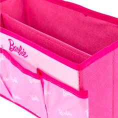 a pink storage bin with two compartments and the word barbie on it's side