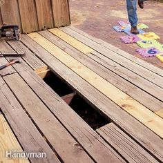 a man standing on top of a wooden deck next to a hole in the ground