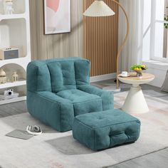 a blue chair and ottoman in a living room