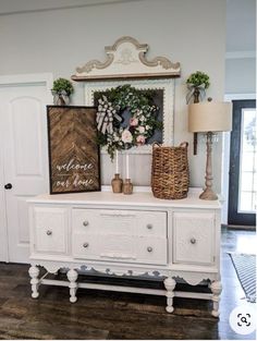 a white dresser with flowers and pictures on it