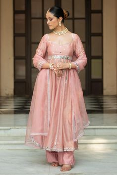 Onion pink padded anarkali with mirror embroidery. Comes with pant and a dupatta.
Components: 3
Pattern: Embroidered
Type Of Work: Mirror
Neckline: Sweetheart
Sleeve Type: Three quarter
Fabric: Semi crepe, Chanderi, Organza, Lining: Semi crepe
Color: Pink
Other Details: 
Attached lining
Product Weight: 1 Kg
Model Height: 5ft 9inches, wearing size S
Closure: Anarkali - Back tie-up
Occasion: Sangeet - Aza Fashions Chanderi Anarkali, Mirror Detail, Onion Pink, Mirror Border, Pink Anarkali, Chanderi Dupatta, Vacuum Storage, Indian Wedding Wear, Organza Dupatta