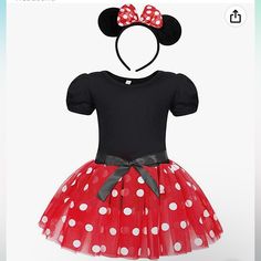 a red minnie mouse dress with white polka dots and a black bow on the head