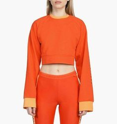 Puma x Fenty by Rihanna Women's Laced Sweatshirt Orange Self: 75% cotton , 17% poly , 5% elastaneRib: 95% cotton , 5% elastaneLace-up drawcord detailScreen and rubber print graphics along sleeveRib-knit trimConvertible styling Fitted Sporty Sweatshirt With Ribbed Cuffs, Stretch Cotton Sweatshirt For Gym, Stretch Cotton Sweatshirt For The Gym, Sporty Fitted Sweatshirt With Ribbed Cuffs, Stretch Cotton Athleisure Sweatshirt, Spring Gym Sweatshirt With Ribbed Cuffs, Fitted Cotton Sweatshirt For The Gym, Cotton Gym Tops With Ribbed Cuffs, Fitted Sportswear Sweatshirt For Loungewear