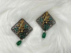 This a beautiful Emerald Green color German silver and gold animal jewelry, in antique looking finish Oxidized Flower detailing, this stud earring has stones, and pearls detailed work. This is very beautiful to look at and a perfect one for regular wear and also Indian weddings.  Color : White, Silver, gold, Green length : 2.5 inch width : 1.75 inch Each earring Weight : 14.9 grams Material : Brass , stones, Pearls Beautiful High Quality, premium jewelry. Free US standard shipping. Hand crafted in India with the finest design, this earring is of premium quality and unique design. It is perfect for Indian Weddings, Diwali, Parties, Birthdays, Anniversaries, new year and even to wear casually. So don't wait any longer, buy this earring now! 1. You will get the exact product same as picture. Unique Metal Earrings For Festive Occasions, Unique Festive Metal Earrings, Dual-tone Jewelry As A Gift, Metal Earrings With Oxidized Finish For Gift, Gift Oxidized Metal Earrings, Oxidized Metal Earrings For Gifts, Green Metal Earrings For Festive Occasions, Gift Earrings With Oxidized Metal Finish, Green Pendant Earrings For Festive Occasions