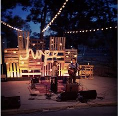 two men are playing music on stage at night