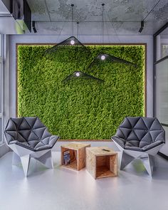 a living room with two chairs and a green wall in the backround area