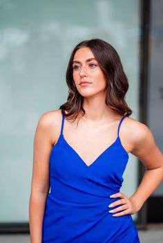 A model in a simple cocktail dress features a v-neckline with delicate straps and a fringe hemline. V-neck Midi Dress With Crisscross Straps For Date Night, V-neck Slip Dress With Straps For Date Night, Elegant V-neck Dress With Crisscross Straps, V-neck Slip Dress With Crisscross Straps For Date Night, Formal V-neck Camisole, Formal V-neck Slip Dress With Delicate Straps, Elegant V-neck Dress With Built-in Bra, Elegant Dresses With Wrap-around Straps For Night Out, Date Night V-neck Midi Dress With Crisscross Straps