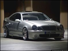 a silver car parked in front of a building