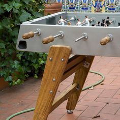 a close up of a foosball on a brick ground