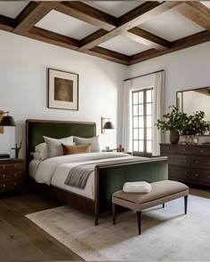 a bedroom with white walls and wood beams