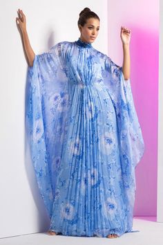 Blue asymmetric kaftan with floral prints and pleated detailing.
Components: 1
Pattern: Printed
Type Of Work: Floral
Neckline: High neck
Sleeve Type: Kaftan sleeves
Fabric: Chiffon
Color: Blue
Other Details: 
Pleated detailing
Back tie-up
Occasion: Party - Aza Fashions