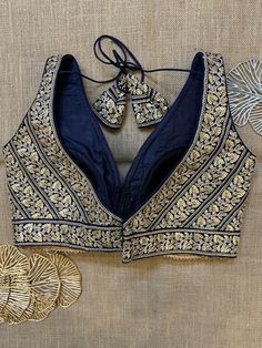 Stunning navy blue embroidered sleeveless saree blouse. Buy designer blouse in USA from Pure Elegance. Disclaimer: The actual product may vary slightly from the image. These are custom orders, hence expect slight variation in color, placement of the motif or buta. ESTIMATED DELIVERYBecause this is a custom order, it would take about 4 weeks from the date of purchase. RETURN POLICY: This product is a custom order and cannot be returned or exchanged. Sleeveless Sari Blouse Design, Sleeveless Sari Blouse, Sleeveless Saree Blouse, Sleeveless Saree, Sari Blouses, Navy Blue Saree, Banarasi Sari, Sleeveless Blouse Saree, Designer Saree Blouse