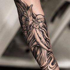 the arm with an angel tattoo on it is shown in black and grey colors,