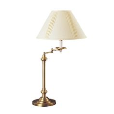 a lamp with a white shade on top of it and a gold metal pole underneath