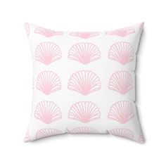 a white pillow with pink scallop print on the front and back of it