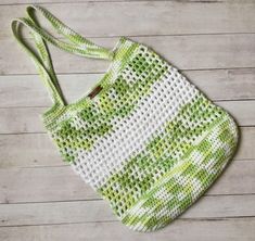 a green and white bag sitting on top of a wooden floor