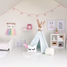 a room with a teepee tent and toys on the floor