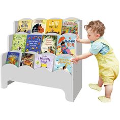 a toddler playing with a book display