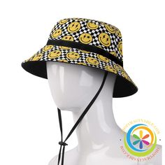 Show off your bright, playful spirit with the Happy Face Bucket Hat! This lightweight hat features a black and yellow checkered pattern covered in cheerful happy faces. Make a bold statement and spread joy wherever you go in this bright and quirky hat. Great for both men and women, it adds a fun pop of color and personality to any outfit. With its happy face print and vibrant colors, this hat is sure to put a smile on your face. Gift one to a friend to help them embrace the whimsical and delightfully playful. Ditch the dull and boring - the Happy Face Bucket Hat will liven up your look! We create Funky Hats for EVERYONE which look amazing all the time...Wear them out for any occasion, any condition - new or old and of course, at any time of the year! Live life in full color with our Bucket Fun Adjustable Wide Brim Bucket Hat, Adjustable Smiley Face Cap, Fun Outdoor Bucket Hat With Short Brim, Fun Short Brim Bucket Hat For Outdoors, Fun Short Brim Bucket Hat For Outdoor, Fun Adjustable Short Brim Hat, Fun Outdoor Bucket Hat, Yellow Novelty Cap, Yellow Novelty Cap Style Hat