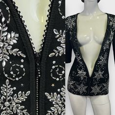 Beautiful Vintage 90s Black Knit Beaded Rhinestone Zipper Cardigan ~ Black knit, round neckline, long sleeves, gold and silver star shaped sequins, clear beaded decorative flowers, plastic rhinestone filled zipper and rhinestone filled zipper head. Zipper head and teeth have rhinestones within. Label missing from neckline. No flaws otherwise. Care label inside at side seam. Fabric content and size not labeled. Fabric feels flexible and has some stretch. 26" long 16" shoulder seam to seam 24" sle Glamorous Fitted Cardigan For Winter, Fitted Sequin Evening Cardigan, Fitted Holiday Cardigan For Party, Fitted Sequined Cardigan For Parties, Fitted Sequin Cardigan For Party, Black Embellished Cardigan For Party, Embellished Fitted Cardigan For Party, Embellished Long Sleeve Cardigan For Party, Fitted Embellished Evening Cardigan