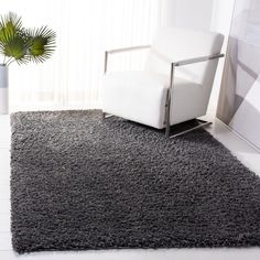 a white chair sitting on top of a gray rug