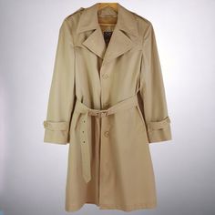 This men's vintage overcoat from the 1970s stands out with its detachable faux fur lining, perfect for staying warm in the winter or transitioning into mid-season wear. Fashioned in the style of a London Fog Coat or Duster, its classic beige color ensures a timeless look. This likely would have been worn to the office during the 70s hippie era.  A superb choice for enhancing your retro vintage collection or adding to your fashionable wardrobe. DRY CLEANED since acquired by HRV.  -  Removable Fau Retro Beige Long Coat, Vintage Long Pea Coat For Spring, Spring Vintage Long Pea Coat, Classic Beige Raincoat For Winter, Classic Long Winter Raincoat, Classic Beige Winter Raincoat, Vintage Winter Raincoat With Pockets, Vintage Outerwear For Spring, Vintage Overcoat