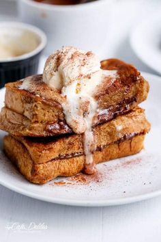 french toast with powdered sugar on top and syrup drizzled over it