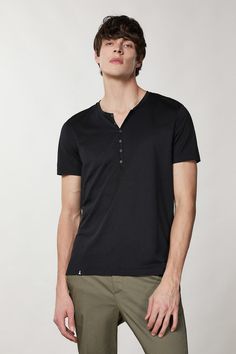 This new take on the Henley T-shirt boasts short sleeves and a button-up rounded neckline. The slim fit, in addition to the cotton and lyocell jersey fabric, define a fresh and current city-perfect look. Cotton and lyocell jersey Slim fit Short sleeves Round neck Small button fastening Main fabric: 67% Lyocell, 33% Cotton Product Code 5M1267_JT23_K102 Jumpsuit Jeans, Henley T Shirt, Blouse Pants, Slim Fit Shorts, Knit Vest, Shop Swimwear, Blazer Dress, Men's Collection, Italian Fashion