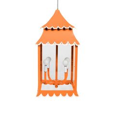 an orange and white bird feeder hanging from a ceiling