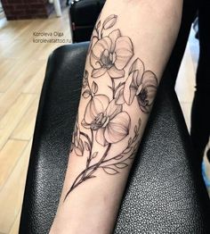 a woman's arm with flowers on it