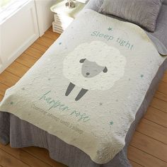 a bed with a sheep comforter on top of it and the words sleep tight