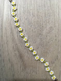 a white and yellow flower beaded necklace