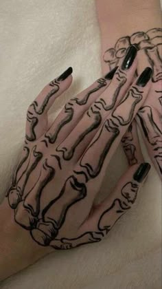 two hands with black and white designs on them