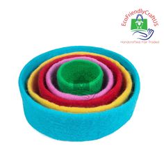 multicolored felt bowls stacked on top of each other in front of a white background