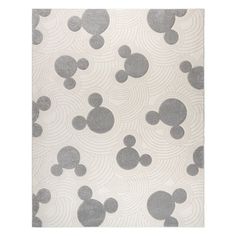 a mickey mouse rug with grey and white circles on it's surface, in front of a white background