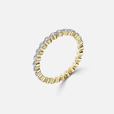 a gold and diamond ring on a white background