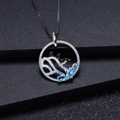 "Dive into a world of Arctic whimsy with our delightful sterling silver and gold necklace, featuring a charming image of three playful penguins frolicking on an iceberg, accented with your choice of blue topaz, nano-sapphire, or rhodolite gemstones. 🐧❄️💎✨ This enchanting piece captures the joy and camaraderie of these beloved creatures in their icy habitat. Meticulously crafted with intricate detailing, the penguins evoke a sense of curiosity and friendship, inviting you to join in their playf Diamond White Sapphire Pendant Necklace, Sapphire Cubic Zirconia Pendant Jewelry, Diamond White Topaz Jewelry Gift, Diamond White Topaz Jewelry As Gift, Diamond White Topaz Jewelry For Gifts, White Gold Topaz Jewelry Gift, Sapphire Color Cubic Zirconia Pendant Necklace, White Gold Necklace With Cubic Zirconia Gemstone Accents, Round Topaz Jewelry As A Gift