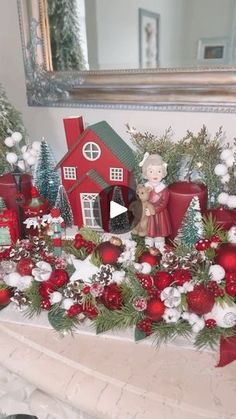 a mantel decorated with red and white christmas decorations