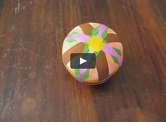 a small round box sitting on top of a wooden table