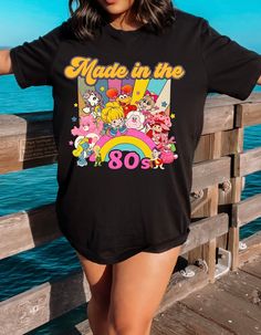 a woman standing on a pier with her arms behind her back and the words make in the 80's printed on it