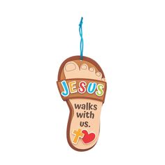 the jesus walks with us ornament is hanging from a string on a white background