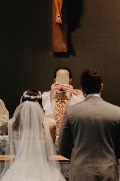 the bride and groom are taking pictures in front of the alter at their wedding ceremony