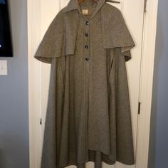 Vintage Women’s Grey Wool Cape With Capelet Sz S From James Holmes Apparel - Made By Sandy Cohen, Corona Ny Cape Has Shirt Type Collar And 4 Buttons Down Front. 2 Slits Shown Where Hands Would Come Through Cape. Caplet Is Detachable By 5 Buttons Under Collar. 100% Wool, Capelet Can Be Raised To Cover Your Head As Seen By In Old Movies! Very London/Little Woman 1800s Vibe. Front Length Collar To Hem 43” Back Length Collar To Hem 46” Back Collar To Caplet Hem 17” 1 Button On Front Missing. Fitted Fall Cape For Costume, Fitted Cape For Fall Costume, Vintage Fitted Cape Outerwear, 1800s Vibe, Sandy Cohen, James Holmes, Hooded Capelet, Wool Capelet, Modern Cape