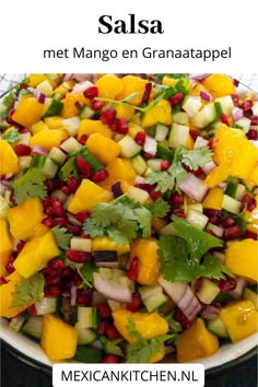 a salad with mangos, celery and pomegranate in it