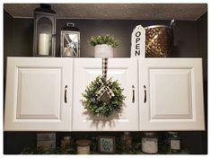 a wreath is hanging on the cabinet doors